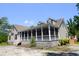 Beautiful home featuring a large screened-in porch, offering a comfortable outdoor living space at 153 Willow Brook Way, Cordesville, SC 29434