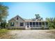 Charming home featuring a spacious screened-in porch, perfect for enjoying the outdoors at 153 Willow Brook Way, Cordesville, SC 29434