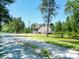 Charming home featuring a welcoming screened-in porch, inviting deck, and a serene gravel driveway at 153 Willow Brook Way, Cordesville, SC 29434