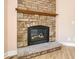 Close-up of a fireplace with a stone surround and black metal insert at 153 Willow Brook Way, Cordesville, SC 29434
