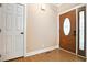 Entryway featuring an elegant wood door with glass and a side light, complemented by neutral-toned walls and wood flooring at 153 Willow Brook Way, Cordesville, SC 29434