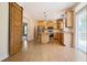 Modern kitchen featuring stainless steel appliances, wooden cabinetry, an island with stools, and a sliding barn door entrance at 153 Willow Brook Way, Cordesville, SC 29434