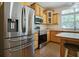Kitchen features stainless steel appliances, wooden cabinets, and a breakfast bar at 153 Willow Brook Way, Cordesville, SC 29434