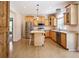 Bright kitchen with wooden cabinets, stainless steel appliances, a center island, and wood flooring, perfect for Gathering gatherings at 153 Willow Brook Way, Cordesville, SC 29434