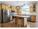 Spacious kitchen features wooden cabinets, stainless steel appliances, and a center island with bar seating at 153 Willow Brook Way, Cordesville, SC 29434