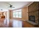 Open floorplan view of living room, showing hardwood floors, fireplace and eat-in kitchen at 153 Willow Brook Way, Cordesville, SC 29434
