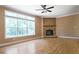 Bright living room with large window, hardwood floors and stone fireplace at 153 Willow Brook Way, Cordesville, SC 29434