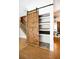 Walk-in pantry with a sliding barn door and custom shelving that provides ample storage at 153 Willow Brook Way, Cordesville, SC 29434