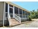 Inviting stairs lead to a spacious screened-in porch, perfect for relaxing and enjoying the outdoors at 153 Willow Brook Way, Cordesville, SC 29434