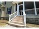 Inviting stairs lead to a charming screened-in porch, perfect for relaxing and enjoying the outdoors at 153 Willow Brook Way, Cordesville, SC 29434