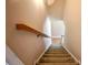 Carpeted stairs with a wooden handrail, offering safe and stylish access to upper levels at 153 Willow Brook Way, Cordesville, SC 29434