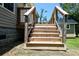 Wooden stairs with metal railing lead to the backyard deck of this lovely home at 153 Willow Brook Way, Cordesville, SC 29434
