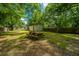 Large backyard with picnic table and mature trees providing ample shade at 1612 Evergreen St, Charleston, SC 29407