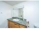Bathroom vanity with green countertop and cabinet with mirror above a sink at 1612 Evergreen St, Charleston, SC 29407