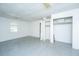 White living room with tile floor, window, and a partially viewed closet space at 1612 Evergreen St, Charleston, SC 29407