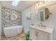 Beautiful bathroom featuring a soaking tub, stylish vanity, and eye-catching wallpaper at 1617 Refuge Run, Charleston, SC 29412