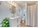 Bright bathroom with a shower behind a patterned curtain and a stylish vanity at 1617 Refuge Run, Charleston, SC 29412