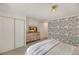 Serene bedroom with wave-patterned accent wall, sliding closet doors, and stylish furniture at 1617 Refuge Run, Charleston, SC 29412