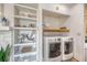 Modern laundry room featuring a laundry machines and open shelving with decor at 1617 Refuge Run, Charleston, SC 29412