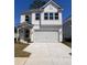 Charming two-story home with white siding, a covered porch, and a spacious two-car garage at 1716 Grovehurst Dr, Charleston, SC 29414