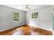 This bedroom features hardwood floors, a ceiling fan and lots of natural light at 1789 Balfoure Dr, Charleston, SC 29407
