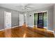 This bedroom features hardwood floors, an ensuite bath, walk-in closet with storage and a ceiling fan at 1789 Balfoure Dr, Charleston, SC 29407