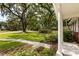 Front porch view of the landscaped yard featuring large trees with Spanish moss at 1789 Balfoure Dr, Charleston, SC 29407