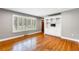 Bright living room featuring hardwood floors, built-in shelving, and a large window with shutter blinds at 1789 Balfoure Dr, Charleston, SC 29407