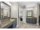 Dual sink bathroom with granite countertops, stylish vanities, and wood-look tile flooring at 2005 Thornhill Dr, Summerville, SC 29485