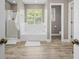 Bright bathroom featuring a soaking tub, separate shower, and a window for natural light at 2005 Thornhill Dr, Summerville, SC 29485