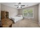 A comfortable bedroom with a ceiling fan, a window providing natural light, and a hanging chair for relaxing at 2005 Thornhill Dr, Summerville, SC 29485