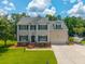 Beautiful two story home with mature trees, manicured lawn, boat parking, and attached two car garage at 2005 Thornhill Dr, Summerville, SC 29485