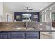 Modern kitchen featuring granite countertops and stainless steel appliances overlooks the living room with fireplace at 2005 Thornhill Dr, Summerville, SC 29485