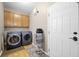 Convenient laundry room with modern washer and dryer, storage cabinets, and stylish flooring at 2005 Thornhill Dr, Summerville, SC 29485