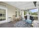Covered porch with rocking chairs, ceiling fans, outdoor grill, and a view of the yard at 2005 Thornhill Dr, Summerville, SC 29485