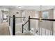 Hallway with a staircase featuring black accents and natural lighting from a window at 2005 Thornhill Dr, Summerville, SC 29485