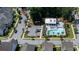 Aerial view of a neighborhood pool and recreation area with ample parking, trees, and lounge chairs at 2017 Geranium Ln, Johns Island, SC 29455