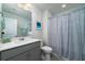 Stylish bathroom with modern vanity and shower with curtain at 2017 Geranium Ln, Johns Island, SC 29455