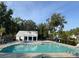 Inviting community pool with lounge chairs and a modern pool house, surrounded by lush greenery at 2017 Geranium Ln, Johns Island, SC 29455