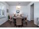 Charming dining room with modern light fixture, dark wood floors, and seating for four at 2017 Geranium Ln, Johns Island, SC 29455