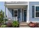 Inviting covered porch with rocking chairs, tasteful plants, and a freshly painted front door at 2017 Geranium Ln, Johns Island, SC 29455