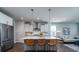 Open-concept kitchen features stainless steel appliances, island with seating, and modern pendant lighting at 2017 Geranium Ln, Johns Island, SC 29455