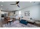 Cozy living room with hardwood floors and modern decor flows seamlessly into the adjacent kitchen at 2017 Geranium Ln, Johns Island, SC 29455