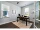 Bright office with dark wood floors, modern desk, and light-filled windows overlooking the exterior at 2017 Geranium Ln, Johns Island, SC 29455