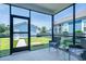 Screened-in porch with outdoor seating and a view of the fenced backyard and adjacent building at 2017 Geranium Ln, Johns Island, SC 29455