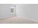 A carpeted bedroom with a window allows light into the room, and has neutral color palette at 212 Terrace View Dr, Summerville, SC 29486
