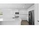 Bright kitchen boasts stainless appliances, white cabinets, quartz countertops and kitchen island perfect for gatherings at 212 Terrace View Dr, Summerville, SC 29486