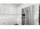 A stainless steel refrigerator stands out next to pristine white cabinets and countertop in a modern kitchen at 212 Terrace View Dr, Summerville, SC 29486