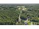 Wide aerial view showing houses amid dense, lush forest, highlighting the area's natural beauty at 214 Deer Ridge Court Ct, Huger, SC 29450