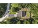 Aerial view of home showcasing its location on a wooded lot with a long driveway at 214 Deer Ridge Court Ct, Huger, SC 29450
